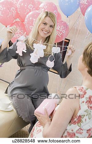 Woman Holding a Gift at a Baby Shower View Large Photo Image Stock Photo - Woman Holding a Gift at a Baby Shower. Fotosearch