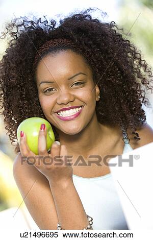 Stock Photography - Woman Holding Apple. Fotosearch