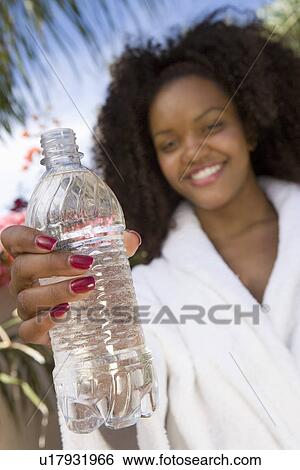 Stock Photograph - Woman Holding Bottle of Water. Fotosearch