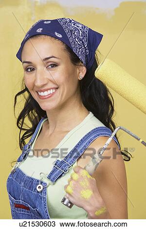Woman holding paint roller, portrait View Large Photo Image Stock Image - Woman holding paint roller, portrait. Fotosearch