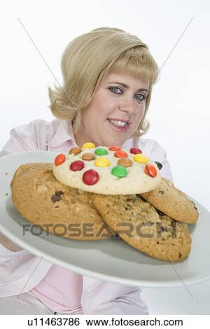 Stock Photograph - Woman Holding Plate of Cookies. Fotosearch