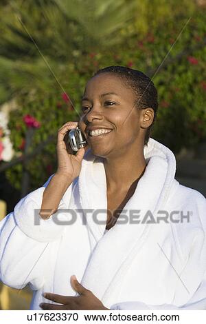 Woman in bathrobe using mobile phone View Large Photo Image Stock Image - Woman in bathrobe using mobile phone. Fotosearch