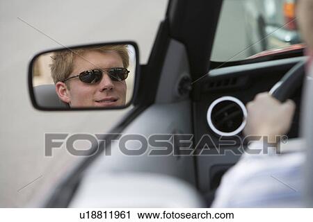 Stock Image - Woman in Side-View Mirror of Car. Fotosearch
