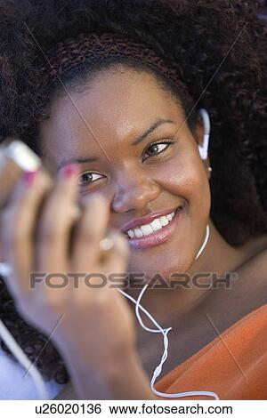 Stock Photograph - Woman Listing to Music. Fotosearch
