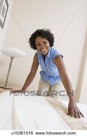Stock Photograph - Woman making a bed. Fotosearch