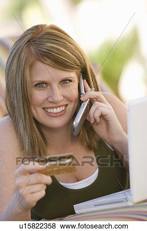 Stock Photo - Woman Making Credit Card Purchase. Fotosearch