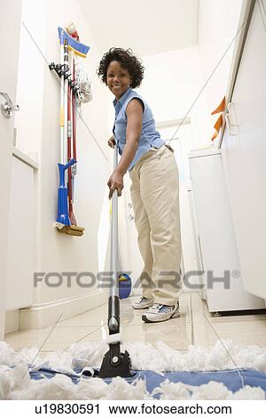 Woman mopping floor View Large Photo Image Stock Image - Woman mopping floor. Fotosearch