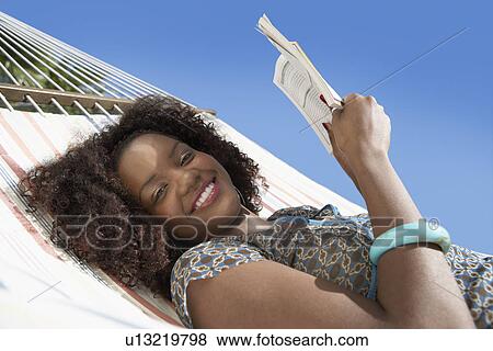 Woman reading in hammock, half length View Large Photo Image Stock Photo - Woman reading in hammock, half length. Fotosearch