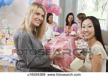Woman Receiving a Gift at a Baby Shower View Large Photo Image Stock Photo - Woman Receiving a Gift at a Baby Shower. Fotosearch