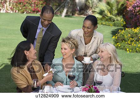Woman receiving present from friends outdoors View Large Photo Image Stock Photo - Woman receiving present from friends outdoors. Fotosearch