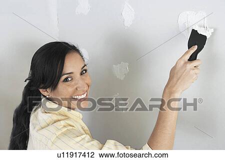 Woman speckling interior wall, elevated view View Large Photo Image Stock Image - Woman speckling interior wall, elevated view. Fotosearch