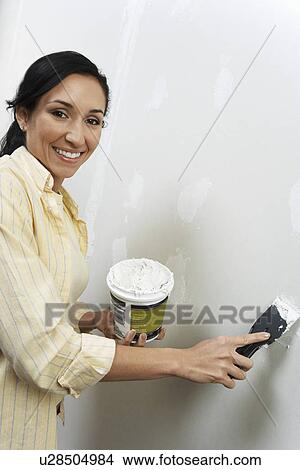 Woman speckling interior wall View Large Photo Image Picture - Woman speckling interior wall. Fotosearch