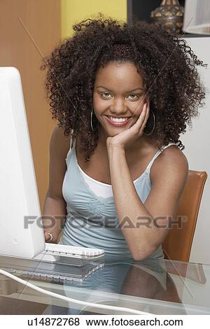 Stock Photo - Woman using computer, (elevated view). Fotosearch