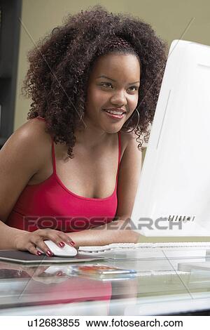 Stock Photography - Woman using computer, (elevated view). Fotosearch