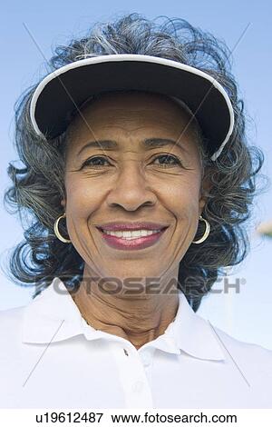 Woman wearing sun visor, portrait View Large Photo Image Stock Photo - Woman wearing sun visor, portrait. Fotosearch