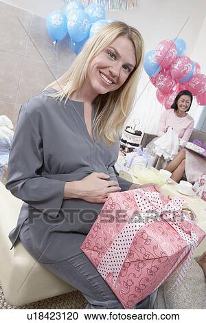 Woman with a Gift at Baby Shower View Large Photo Image Stock Image - Woman with a Gift at Baby Shower. Fotosearch