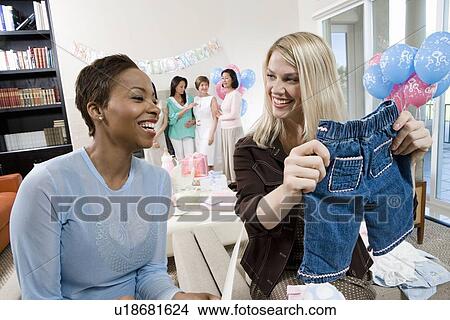 Women at a Baby Shower with baby Clothes View Large Photo Image Picture - Women at a Baby Shower with baby Clothes. Fotosearch