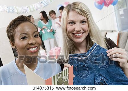 Women at a Baby Shower with baby Clothes View Large Photo Image Stock Photography - Women at a Baby Shower with baby Clothes. Fotosearch