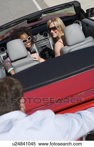 Stock Photography - Women Riding in Pushed Car. Fotosearch