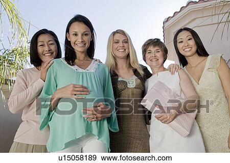 Stock Photo - Women standing outside celebrating a Baby Shower. Fotosearch