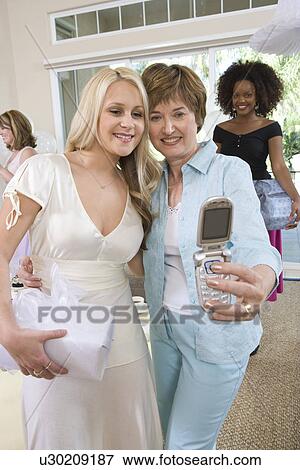 Women Taking Pictures o at Party View Large Photo Image Stock Photo - Women Taking Pictures o at Party. Fotosearch
