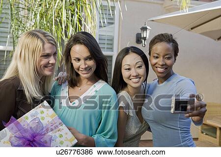 Stock Photograph - Women using a Digital camera at a Baby Shower. Fotosearch