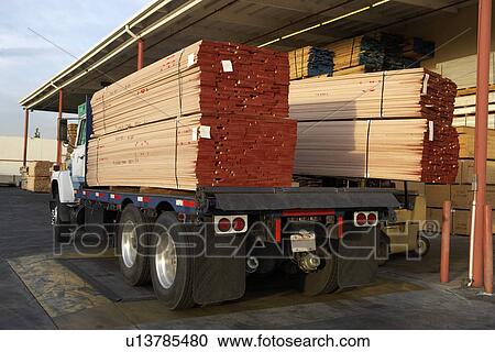 Stock Image - Wood stacked on a truck, rear view. Fotosearch