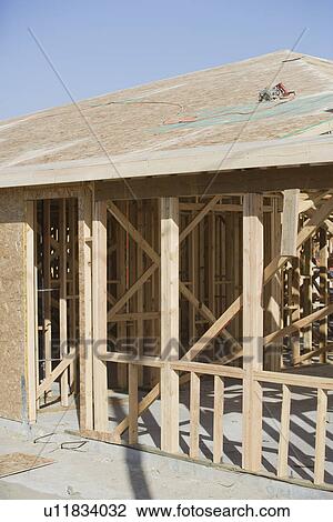 Stock Image - Wooden house construction. Fotosearch