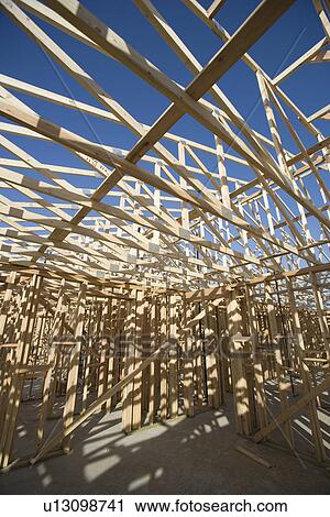 Stock Image - Wooden house construction. Fotosearch