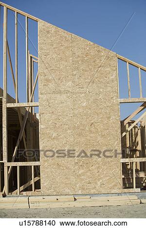 Stock Image - Wooden house construction. Fotosearch