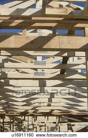 Stock Image - Wooden house construction. Fotosearch