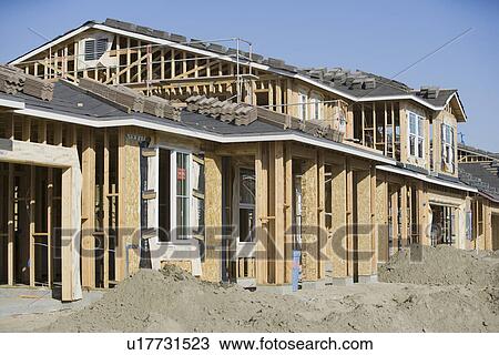 Stock Image - Wooden house construction. Fotosearch