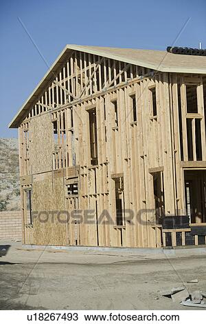 Stock Image - Wooden house construction. Fotosearch