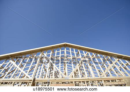 Stock Image - Wooden house construction. Fotosearch