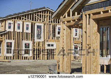 Stock Image - Wooden house constructions. Fotosearch