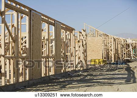 Stock Image - Wooden house constructions. Fotosearch
