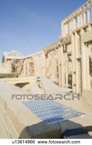 Stock Photograph - Wooden planks stacked on construction site. Fotosearch