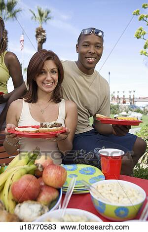 Stock Image - Young Couple at Barbecue, Portrait. Fotosearch