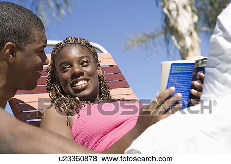Young Couple Reading Under Palm Tree View Large Photo Image Stock Photo - Young Couple Reading Under Palm Tree. Fotosearch