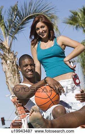Young Couple with Basketball, Outdoors, Portrait View Large Photo Image Stock Photo - Young Couple with Basketball, Outdoors, Portrait. Fotosearch