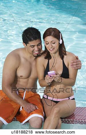 Young Couple with Mp3 Player, Relaxing at Swimming Pool View Large Photo Image Stock Photo - Young Couple with Mp3 Player, Relaxing at Swimming Pool. Fotosearch