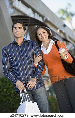 Young couple with shopping bags, portrait View Large Photo Image Stock Image - Young couple with shopping bags, portrait. Fotosearch
