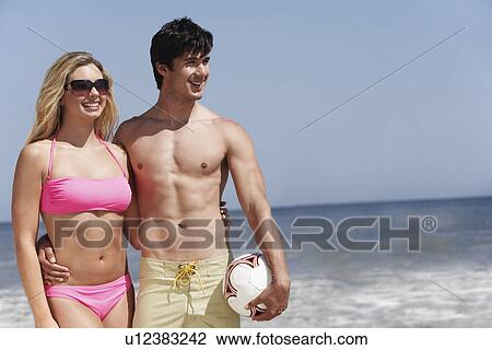 Young couple with volleyball on beach View Large Photo Image Stock Image - Young couple with volleyball on beach. Fotosearch