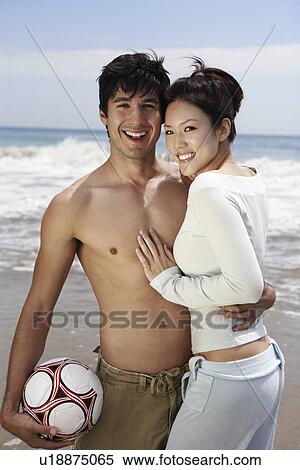 Young couple with Volleyball on beach View Large Photo Image Stock Photography - Young couple with Volleyball on beach. Fotosearch