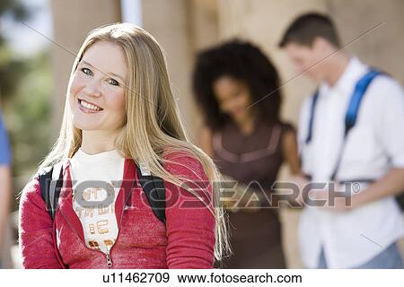 Stock Photo - Young female student smiling at camera. Fotosearch