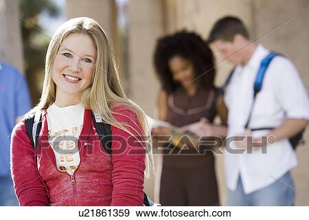 Stock Photo - Young female student smiling at camera. Fotosearch