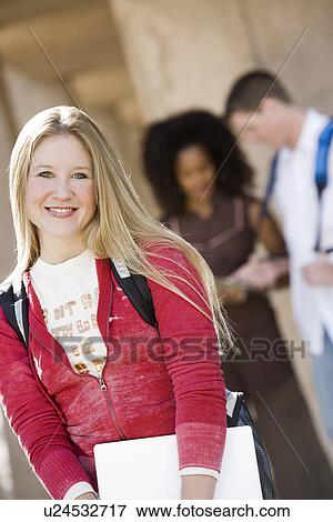 Young female student smiling at camera View Large Photo Image Stock Photo - Young female student smiling at camera. Fotosearch