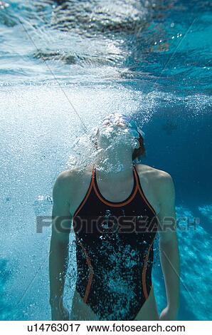 Stock Photo - Young female swimmer in swimming pool. Fotosearch