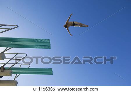 Stock Photography - Young man diving from diving board. Fotosearch