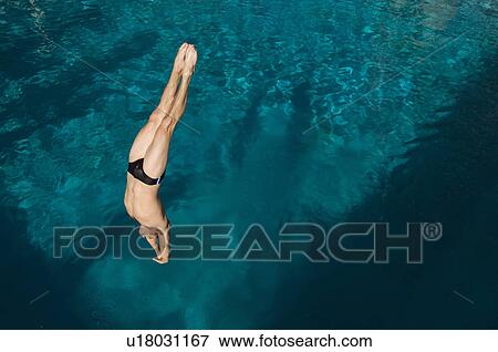 Young man diving into swimming pool View Large Photo Image Stock Photo - Young man diving into swimming pool. Fotosearch